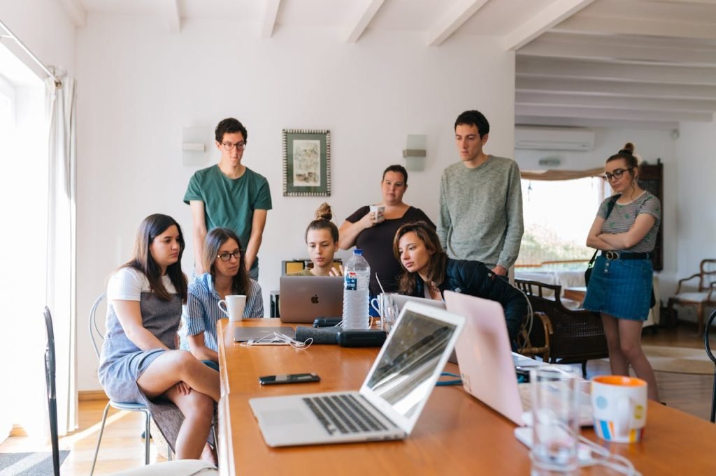 Mastering the First Impression: Your intriguing post title goes here Group of young professionals engaged in a collaborative meeting in a modern office setting.